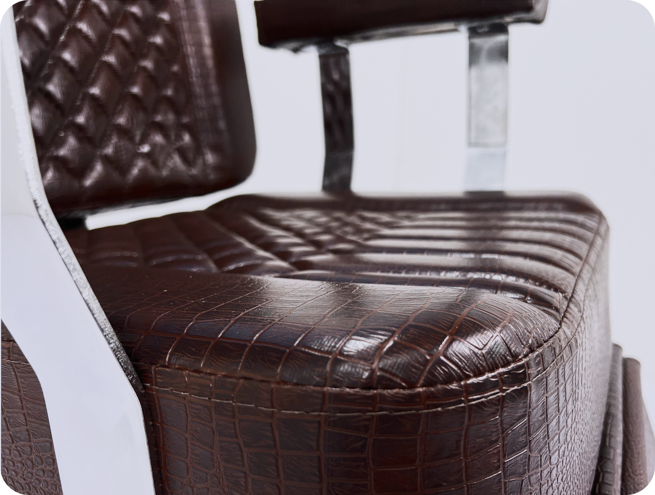 A black leather armchair with dark wood arms in a modern room setting.